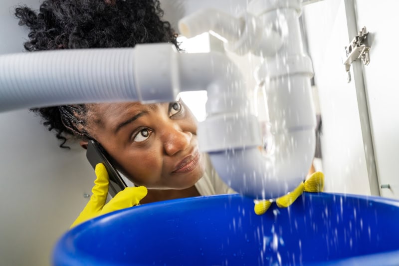 Technician working on leaking pipes.